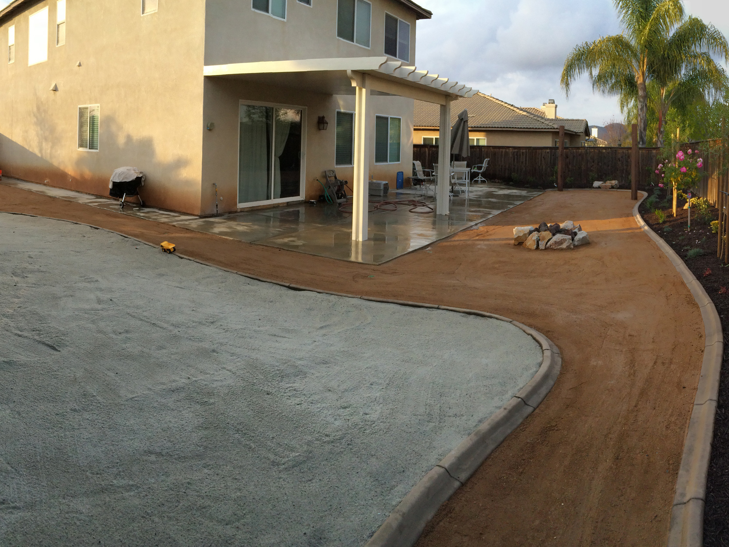 Playground area with fire pit and patio cover in Menifee McCabe's Landscape Construction