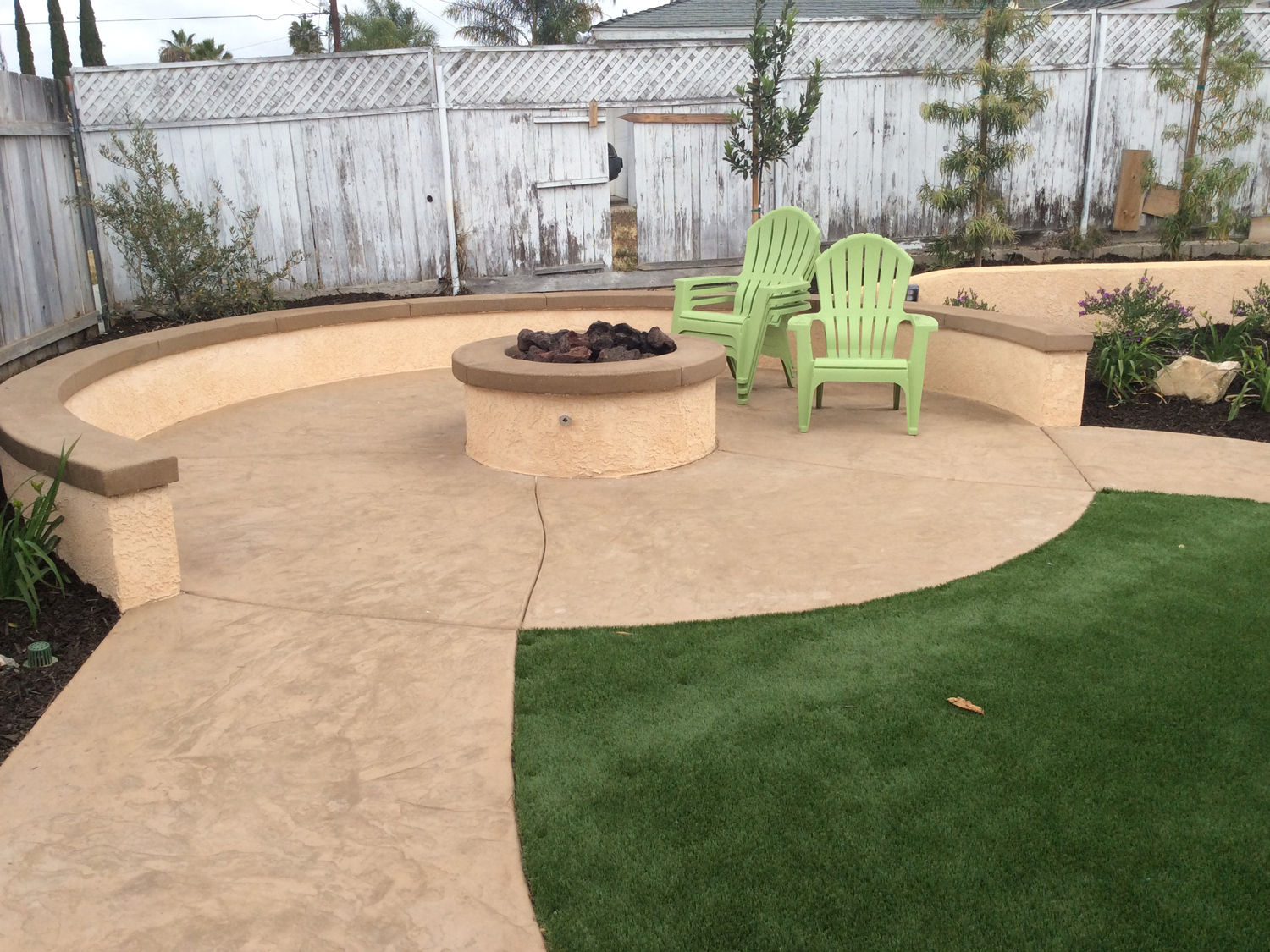 Fire pit with sitting wall and artificial turf in Oceanside McCabe's Landscape Construction