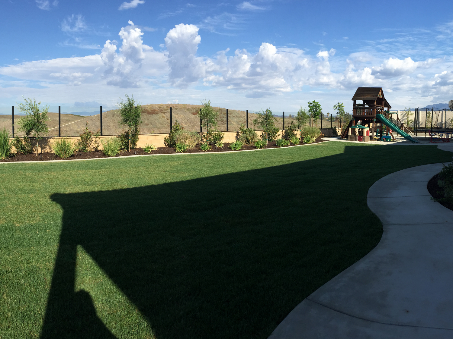 Rear lawn with playground area in Temecula McCabe's Landscape Construction