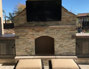 Outdoor fireplace with TV set and storage cabinets