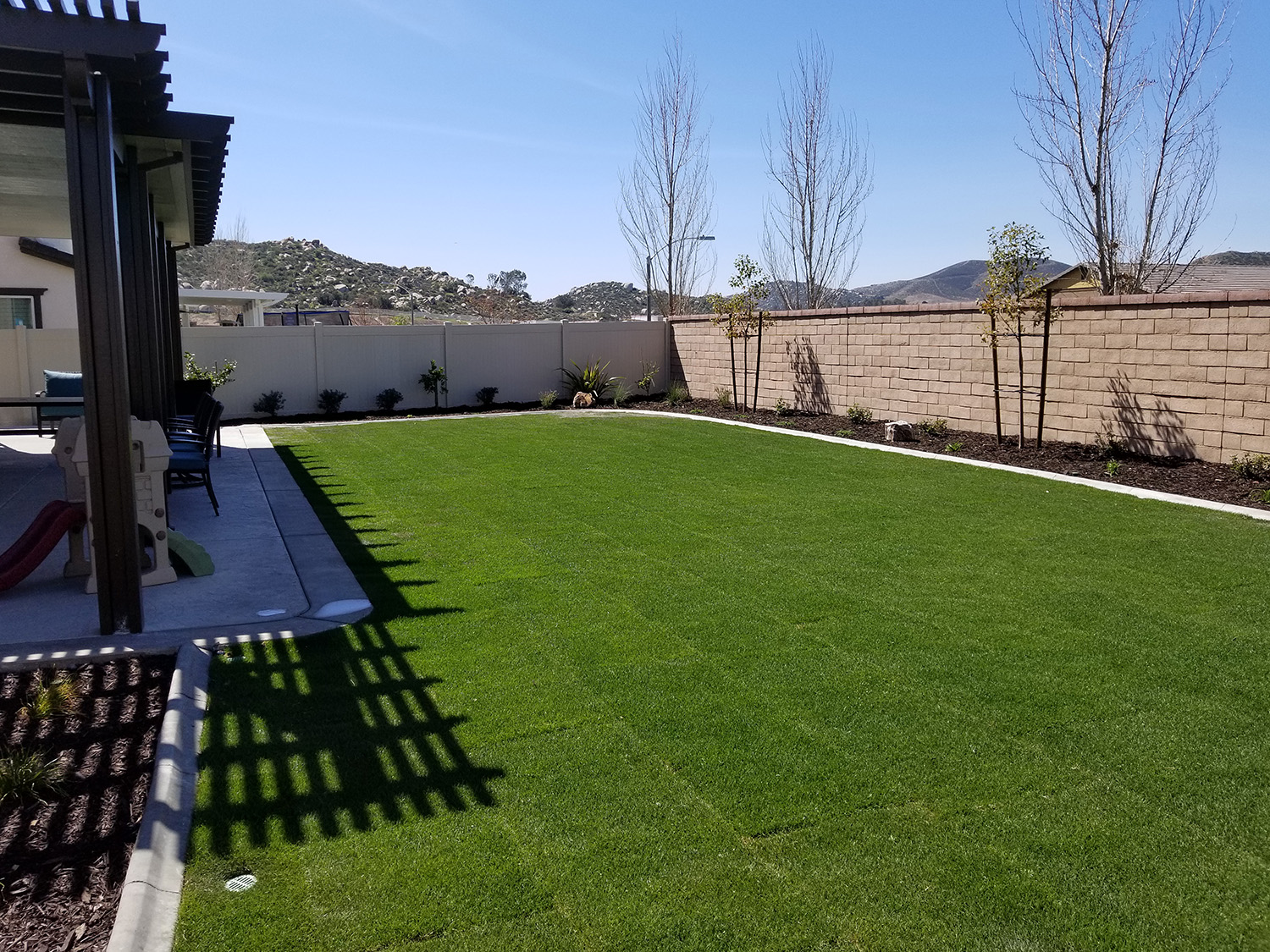 Lawn, plantings, patio and cover