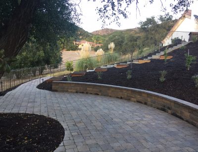Pavers, wall, planter boxes on hill