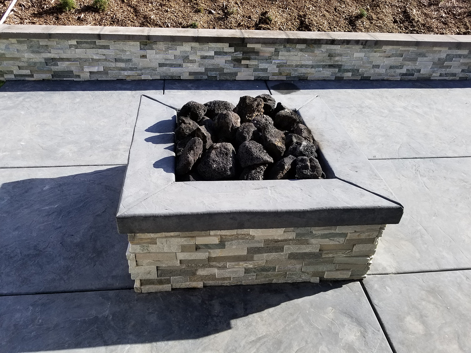 Fire pit with retaining wall and stamped concrete