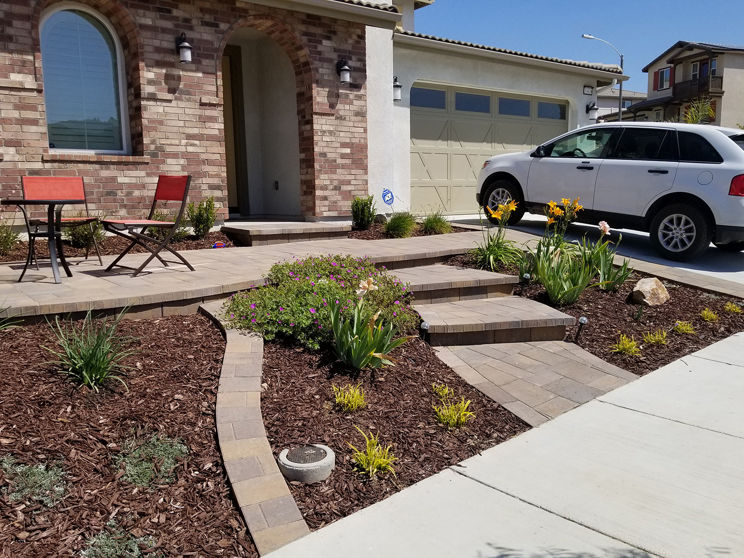 Front landscape with paver patio and pathways