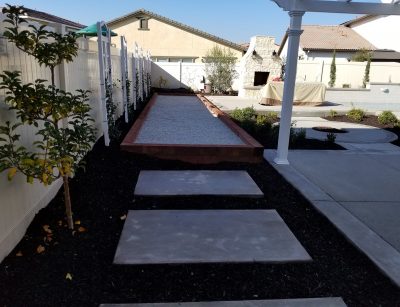 Bocce ball court, plantings, outdoor fireplace