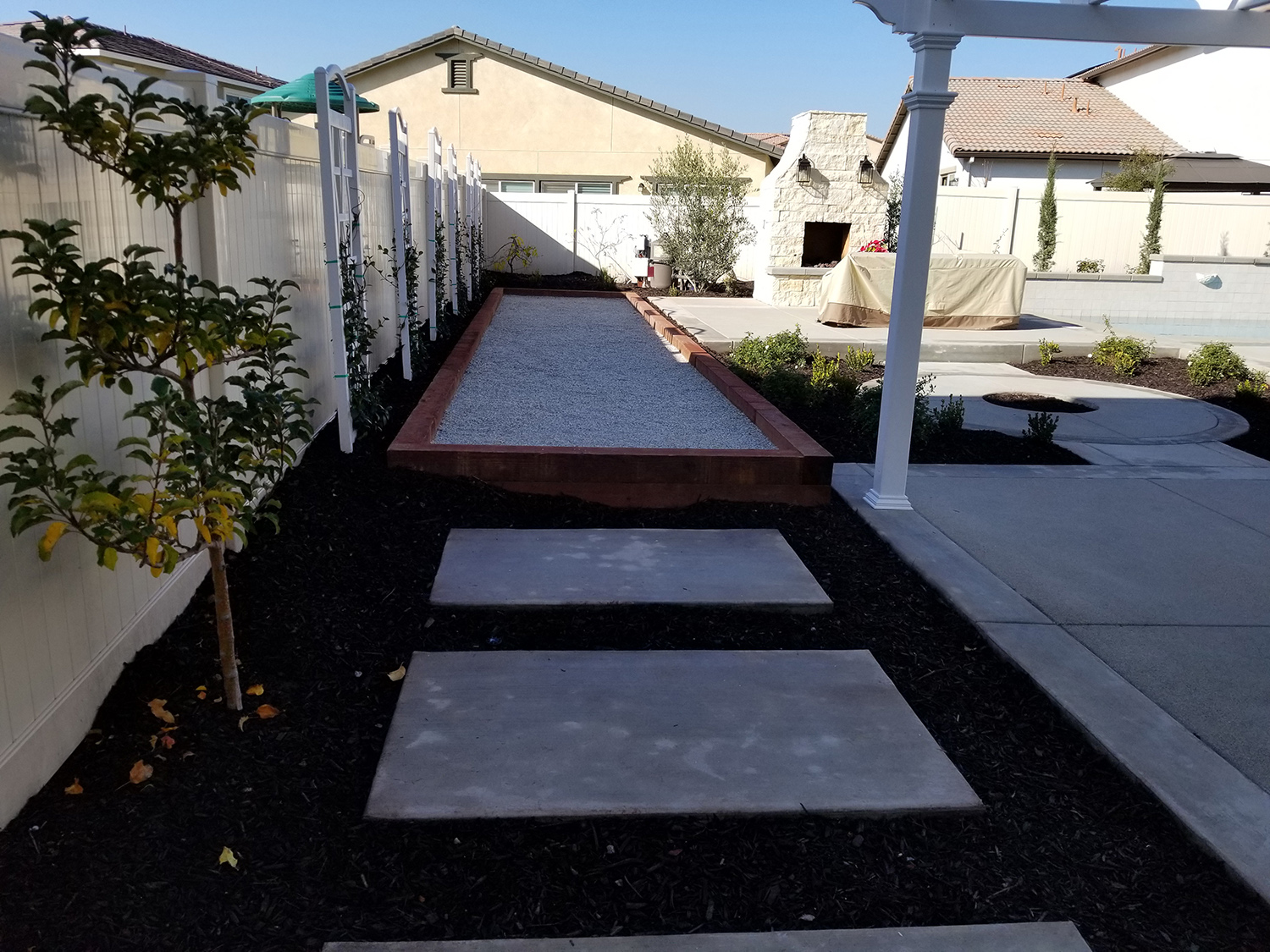 Bocce ball court, plantings, outdoor fireplace