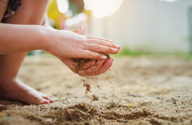 child playing in sand